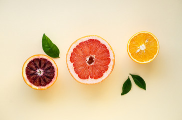 Wall Mural - Halves of various citrus fruits on a light background