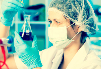 Wall Mural - scientist holds and examine samples in a laboratory