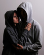 © Arsentyev Vladimir - Man and woman hooded hugging, low key