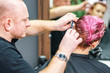 © okskukuruza - Hairdresser cuts pink hair.