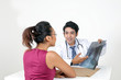 © oqba - Male doctor female patient discussion consultancy on white background x ray tablet check up happy point