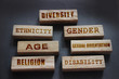 Diversity ethnicity gender age sexual orientation religion disability words written on wooden block. Equality and diversity concept