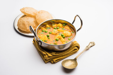 Wall Mural - Aloo Puri or Potato curry with fried Poori, popular Indian breakfast / lunch / dinner menu.