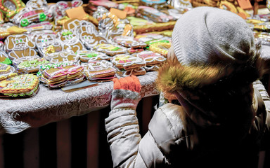 Sticker - Child at Colorful gingerbreads at the Riga Christmas Market