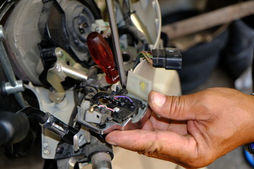 Motorcycle repair technicians check the wiring or repair of the motorcycle.