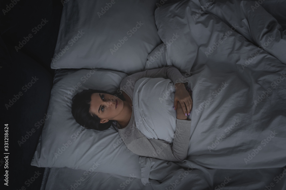 top view of woman with sleep disorder lying in bedroom - obrazy, fototapety, plakaty 