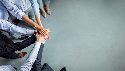 Unrecognizable Coworkers Holding Hands Standing In Office, Cropped, Above View