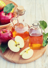 Wall Mural - Apple cider vinegar in a bottle. Selective focus.