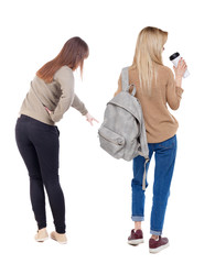 Back view of two pointing girl in sweater.