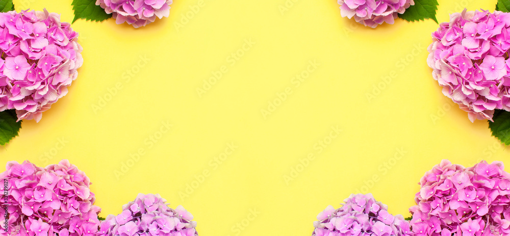 Frame of Beautiful flowers of pink hydrangea on yellow background top view flat lay copy space. Flower card. Holiday, congratulations, happy mothers day. International Women's day. Festive background - obrazy, fototapety, plakaty 