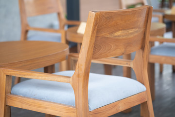 Cozy wood chair with grey pillow