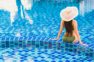 Portrait beautiful young asian woman relax around swimming pool in hotel resort