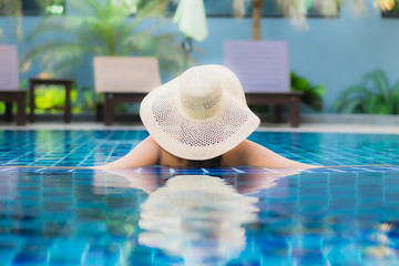 Portrait beautiful young asian woman relax around swimming pool in hotel resort