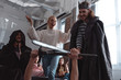 © LIGHTFIELD STUDIOS - men in costume of king fighting with knight with toy swords near friends
