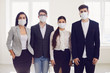 © Studio Romantic - Danger of infection of the virus coronavirus infection. Group people businesspeople in medical mask at office.