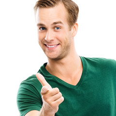 Wall Mural - What about You? Cheerful man in green casual clothing, showing to you with index finger, isolated over white background. Pointing at something over finger. Square composition picture.