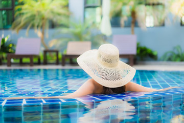 Portrait beautiful young asian woman relax around swimming pool in hotel resort