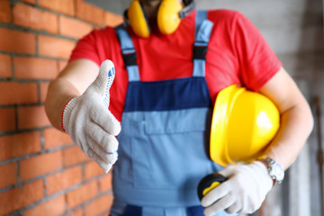 Worker at construction site offering hand to shake