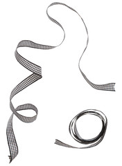 Wall Mural - Black check ribbon curl isolated on white background. Black plaid ribbon bow and curl isolated on white background