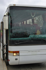 white tourist bus close up standing in the Parking lot waiting for passengers