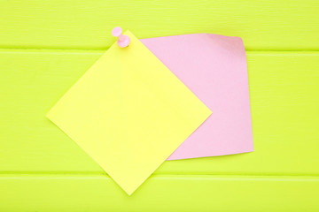 Paper sticky notes on green wooden table