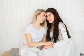  two beautiful young women on the bed