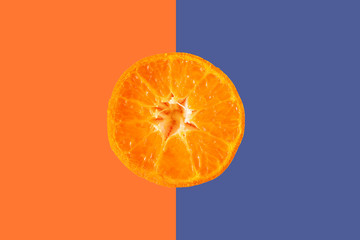 Wall Mural - the slice of orange citrus fruit against the colorful pastel background, simple minimalism concept