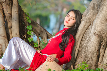 Portrait of Vietnamese girl traditional red dress,Beautiful young asian woman wearing Vietnam