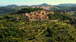 An Italian village with green meadows all over the village. Aerial view with a drone of the beautiful and old village of Monticchiello in Tuscany, Italy	