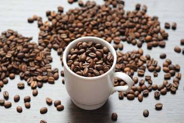 coffee beans in Cup on wood background