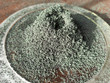 A pile of green powdery substance, chromium oxide, a chemical reaction product of a volcano.