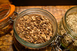 Tastes of gin, botanicals ingredients for gin distillery process, pot with dried orris root
