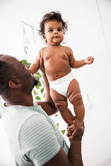 Loving father is holding cute newborn daughter