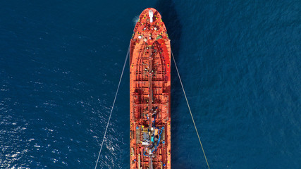 Aerial drone top down photo of fuel tanker ship anchored in Mediterranean industrial port