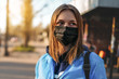 © sushytska - Coronavirus in Europe. the girl is standing by the road in a protective medical mask.