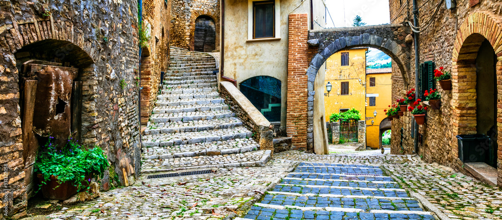 Traditional medieval villages of Italy - picturesque old floral streets of Casperia, Rieti province - obrazy, fototapety, plakaty 
