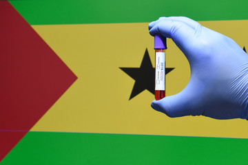 Corona virus or Covid-19 in sao tome , sample blood tube in hand with sao tome flag on background