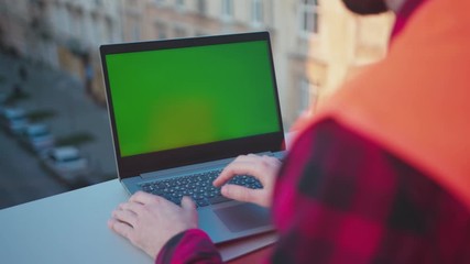 Wall Mural - Man hands engineer using laptop computer with green screen on balcony worker project occupation builder technology mock-up professional male safety device computer slow motion