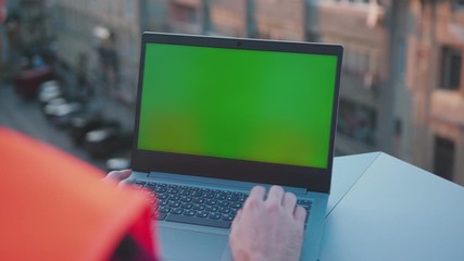 Wall Mural - Slow motion hands engineer using laptop computer with green screen on balcony worker project occupation builder technology mock-up professional male safety device computer close up
