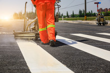 Road Workers Use Hot-melt Scribing Machines To Painting Pedestrian Crosswalk On Asphalt Road Surface In The City.