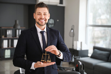 Canvas Print - Portrait of male lawyer with scales in office