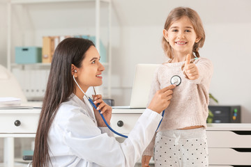 Sticker - Pediatrician examining little girl in clinic