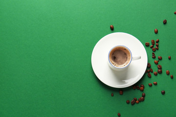 Cup of hot coffee on color background