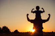© altanaka - Father and son playing in the park at the sunset time.
