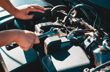 Machanic holding wrench in the repair garage,Car maintenance concept