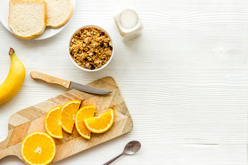 Wall Mural - Vegetarian breakfast with granola and fruits on white background top-down frame copy space