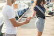 © Studio Peace - Lovers, boy and girl, walk on a wooden pier and hold hands.