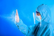 Cleaning and Disinfection A medical man in a medical protective full protected suit , a means of protection against the virus, uses a spray to disinfect . Epidemia Coronavirus. Covid-19