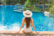 © siraphol - Portrait beautiful young asian woman relax around swimming pool in hotel resort