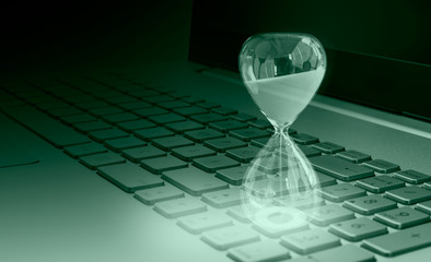 Close-up of white hourglass on laptop keyword